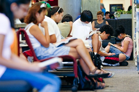 Patrons pack the Bellevue branch of the King County Library to take advantage of the cool air conditioning as record-breaking heat brought triple-digit temperatures to the region on Wednesday.