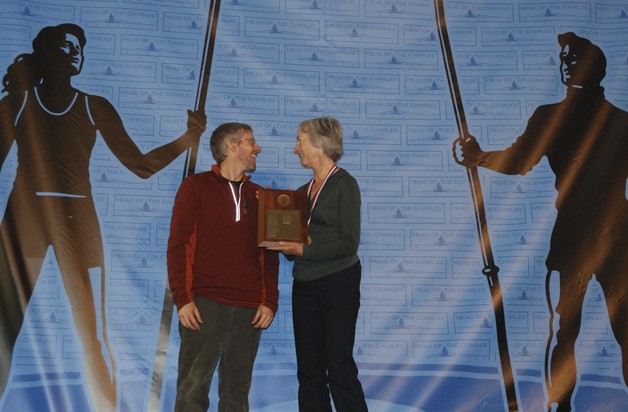 Jan Stone of Bellevue accepts an award from former Olympic rower Steve Tucker after winning the Head of the Charles Regatta.