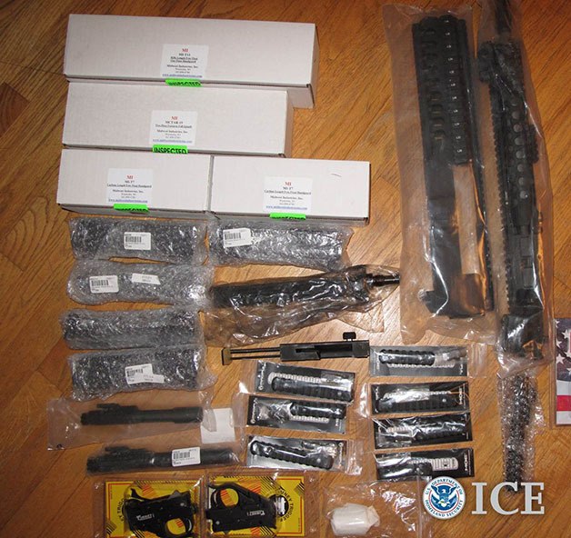 This picture provided by U.S. Immigration and Customs Enforcement shows firearms parts placed in false packages for illegal shipments to Thailand.