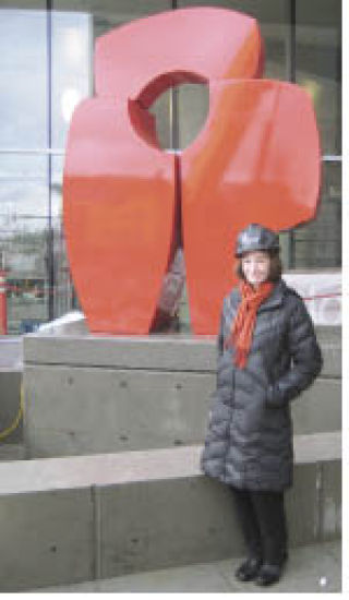 Julie Speidel stands in front of her sculpture