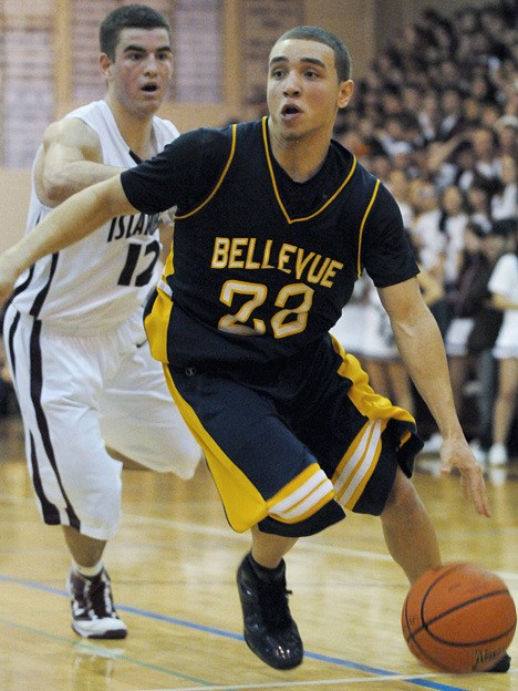 Wolverine guard Aaron Bright (22) drives to the basket at Mercer Island on Friday. Bellevue won 67-59 to remain undeafeated.