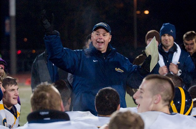 Wolverine head coach Butch Goncharoff addresses the team after a 35-14 playoff win over Lakes at Harry Lang Stadium in Lakewood on Friday