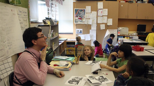 Sherwood Forest Elementary teacher Mariano Lizano works with students on identifying facial features in Spanish.