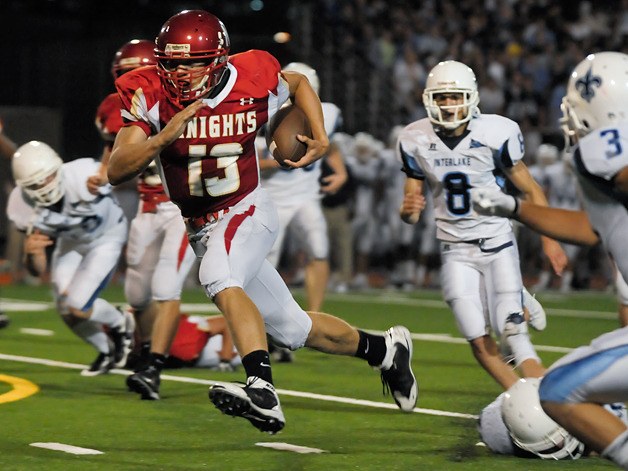 Knights QB Isaac Dotson (13) breaks through the Interlake defense for the first of his two rushing touchdowns in the third quarter at Newport High School in Bellevue on Friday.