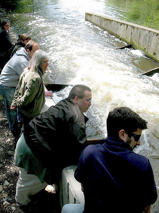 One of the stops on the group's tour was the Kelsey Creek fish ladder. From right are Jamie Wine from People For Puget Sound