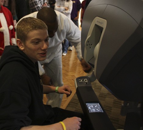 Curtis Reid of Lake Washington High School prepares to work with the robotic da Vinci surgical system at Overlake Hospital.