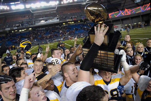 The Bellevue Wolverines celebrate their fourth consecutive 3A state football title after beating O'Dea 35-16 at the Tacoma Dome on Friday.