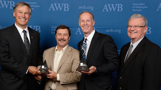 Gov. Jay Inslee (left) presents Sen. Mark Schoesler and Sen. Rodney Tom with the 2013 Jim Matson Award. Pictured at right is AWB Board Chair Doug Bayne.