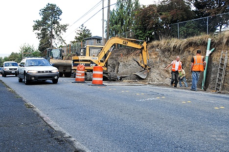 Workers prepare Northeast Eighth Street west of Downtown Bellevue for upcoming closure to build new sidewalks from 96th Avenue Northeast to Lake Washington Blvd. The work will happen in two stages.