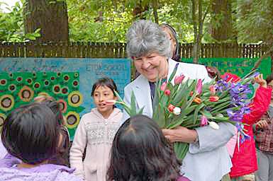 Each student at Eton School presented a flower to founder Dr. Patricia Feltin to celebrate her retirement after 34 years.