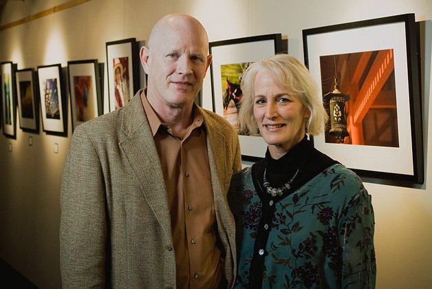 John and Lisa Merrill stand by an exhibit of their work on the art wall at the South Bellevue Community Center. To celebrate the five-year anniversary of the art wall