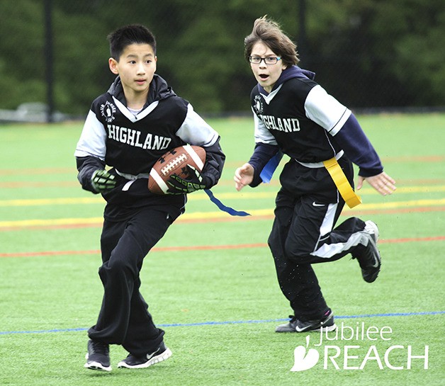 A pair of Highland Middle School students play in a Club Jubilee flag football game