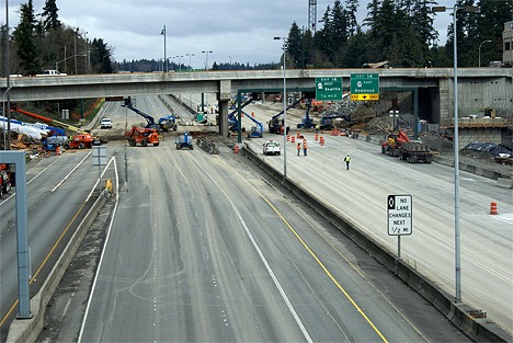 Workers begin cleaning up after the removal of the old N.E. 12th Bridge in downtown Bellevue over the weekend. I-405