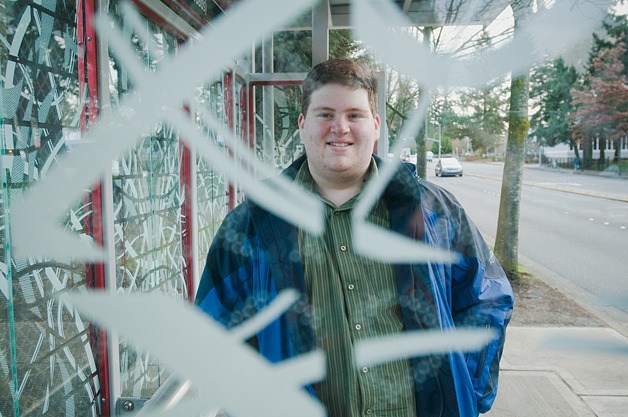 David Warwick stands at a bus stop