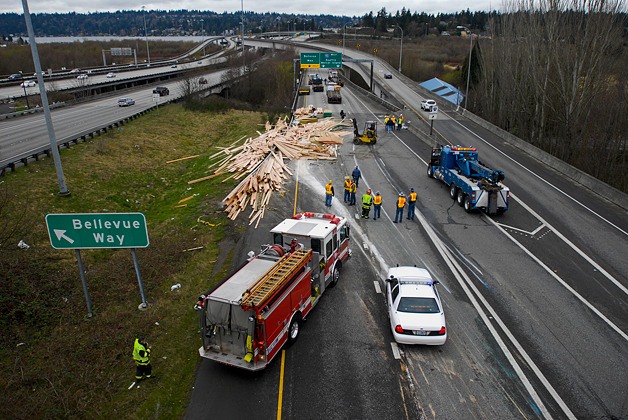 An overturned truck spilled a load of lumber across the roadway blocking the Westbound I-90 ramps from both directions of I-405 in Bellevue on Tuesday.