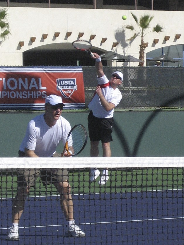 Kevin Regan serves as partner Doug Morrison awaits a return during the men's 3.0 senior national championship final round in Indian Wells