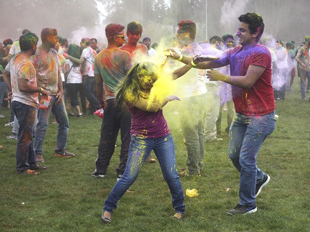 A man throws yellow powder at a woman during Holi in Bellevue's Crossroads Park on March 19.