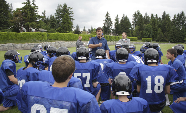 Bellevue Christian coach Greg Schneider talks with his team before a practice during the spring.