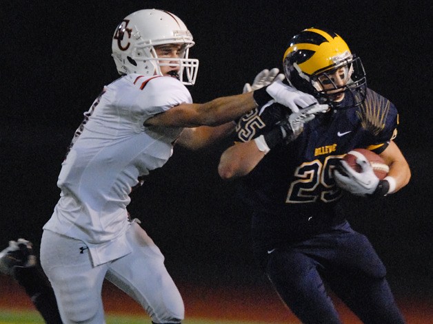 Wolverine RB Ari Morales (25) eludes an Eastside Catholic tackler during a playoff game at Bellevue on Friday.