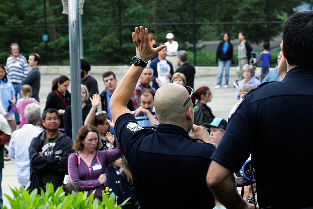 John Nourse (left) of the Bellevue Police Departent addresses the crowd at July 12's Bridle Trails Night Out.