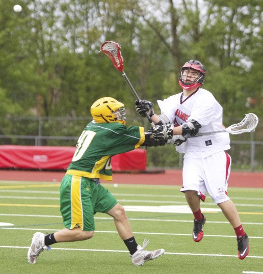 A Sammamish player fires a pass over Blanchet defender  in Wednesday’s Boys Division II semifinal win over the Braves.  With the win