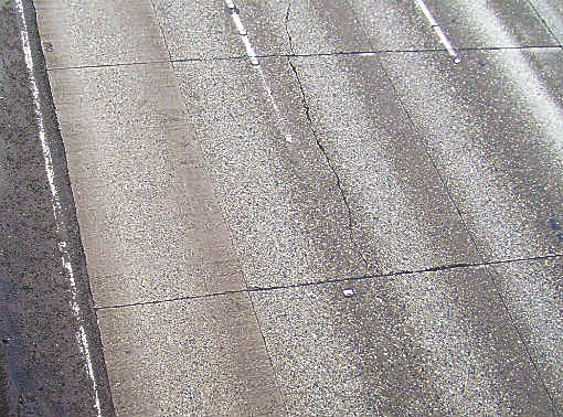 The pavement panel in the center of the photo provides a snapshot of the different kinds of pavement damage on northbound I-405 in Bellevue. Besides the large crack down the middle of the panel