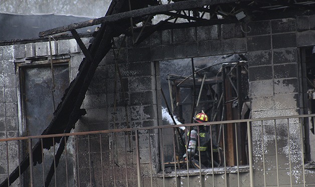 Firefighters were still hosing down hotspots at A&M Auto Repair Wednesday afternoon