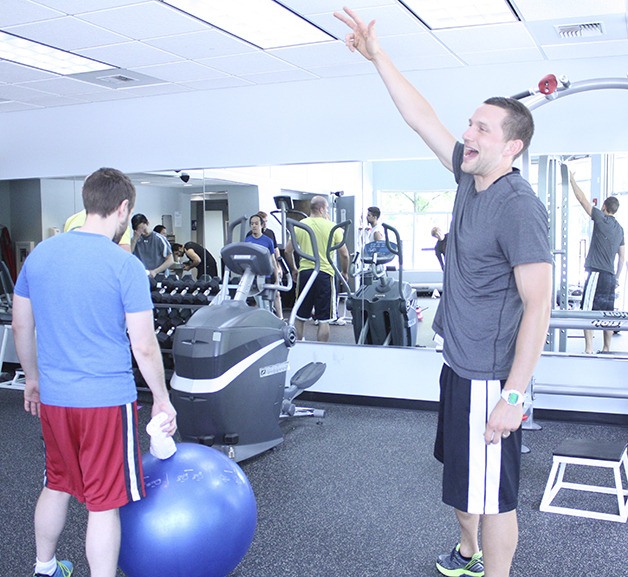 Nick Merril points to Bungie employees during a workout session.