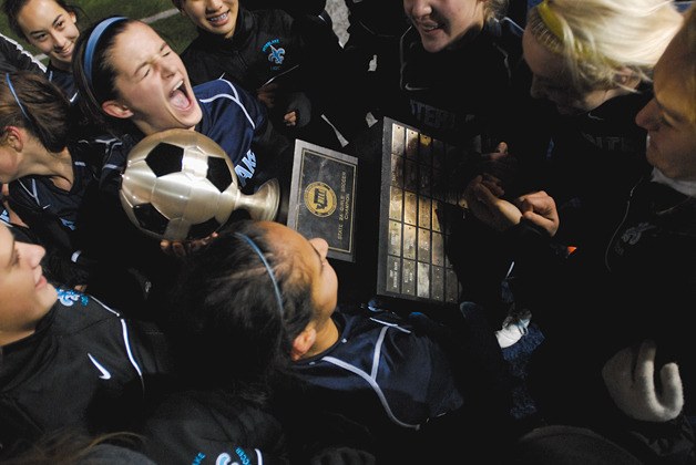 The Interlake Saints celebrate their 2A state soccer title at Shoreline Stadium in Shoreline on Saturday. Interlake won the championship game 1-0 over Cedarcrest.