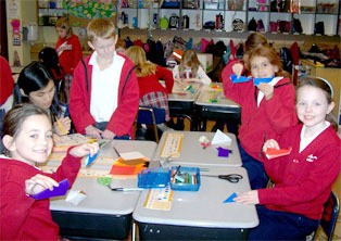 Students from St. Louise put together Origami whale pins that they gave to people who donated to Japan relief