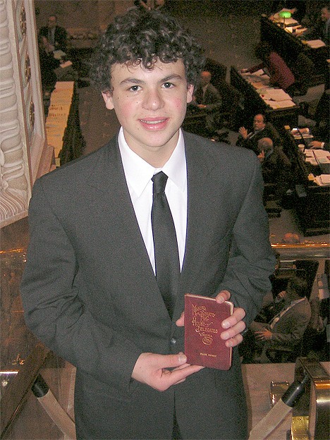 Jonathan Koch holds his great-grandfather’s Page Handbook from when he served as a page in 1926 in Virginia.