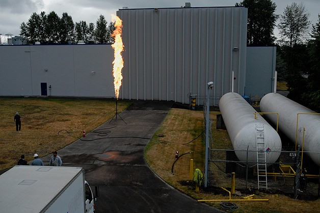 Contractors burn propane vapors as part of work on new safety and control valve installation on storage tanks at the Safeway Bread plant off Northup Way in Bellevue on Monday.