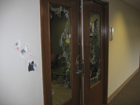 A man wielding a heavy axe caused this damage to the front entrance of a Bellevue collection agency Tuesday morning.