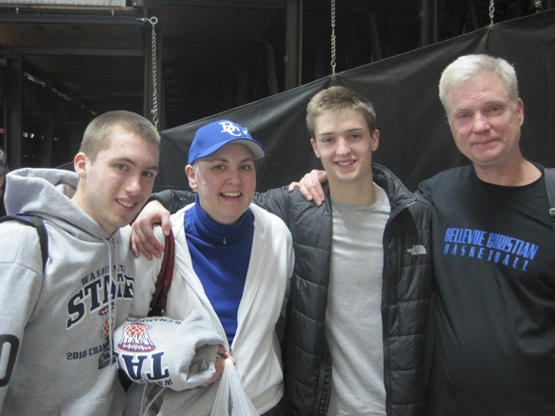 Jan and Mike Downs stand with David Downs and a teammate and friend after a state tournament game.