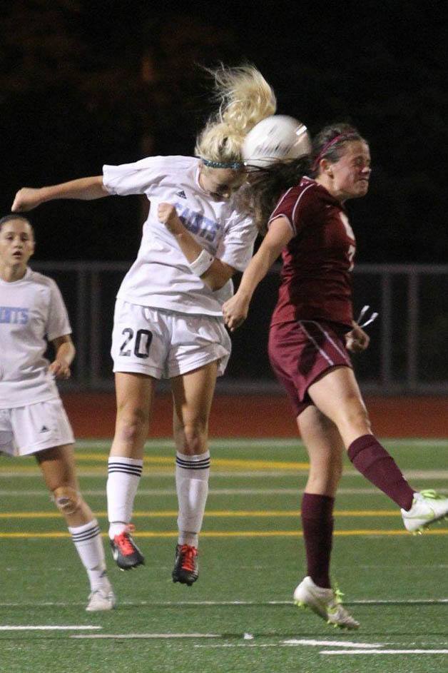 Interlake's Isabel Farrell heads the ball from a Mercer Island player during the Saints' win. Farrell had one goal and an assist in her team's 3-2 win.