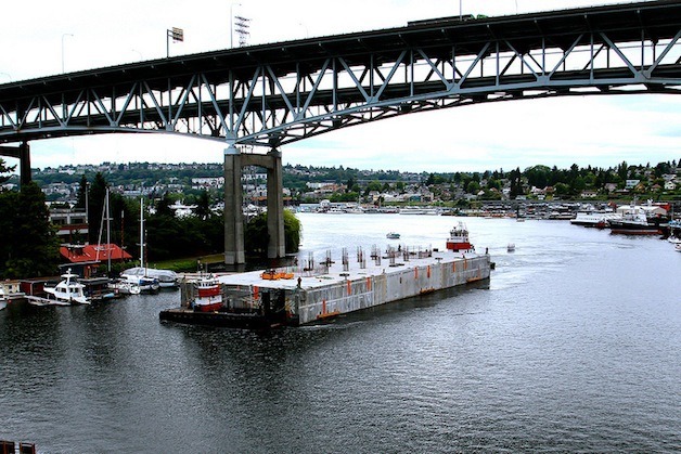 A pontoon for the new SR 520 bridge moves under the Ship Canal Bridge in Seattle.