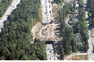 An aerial view of the Wilburton Tunnel in July shows trucks removing dirt in preparation for knocking down the tunnel next weekend.