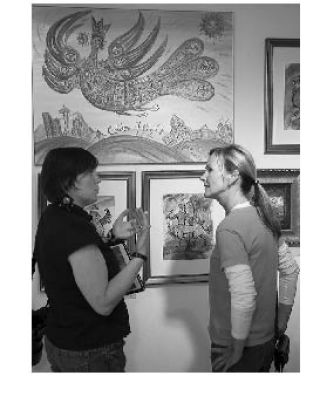 Katya Palladina (left) talks with Janelle Davidson in front of Palladina’s “Golden Flight” painting Aug. 1 at Upfront Gallery in Issaquah. Palladina will display some of her mixed-media paintings Oct. 11 and 12 at the Sammamish Art Fair. The art fair runs 10 a.m. to 5 p.m.  both days at the Sammamish City Hall