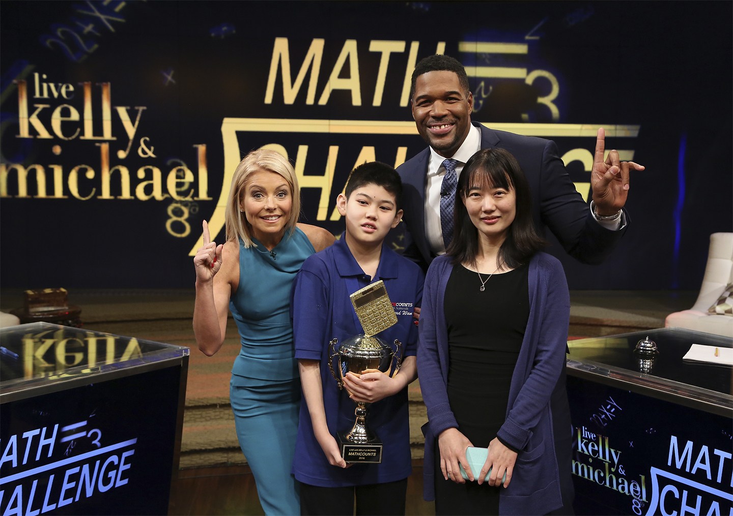 Kelly Ripa and Michael Strahan talk with Edward Wan during the production of "LIVE with Kelly and Michael" in New York on Tuesday