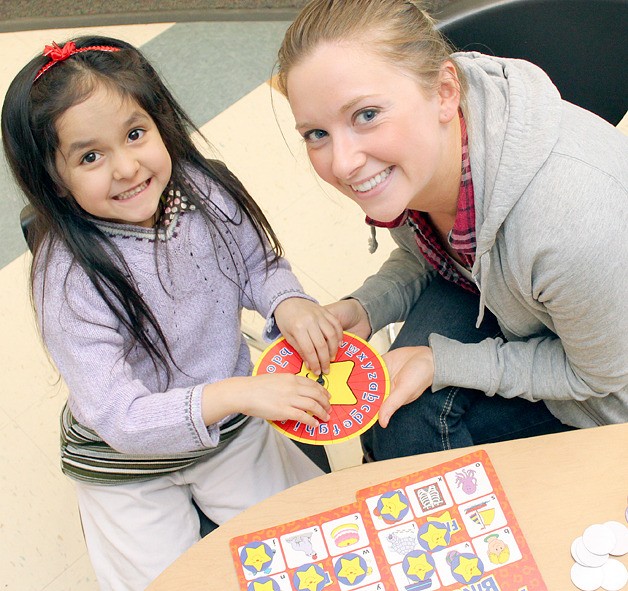 Bellevue School District volunteer Kelsey Green works with student