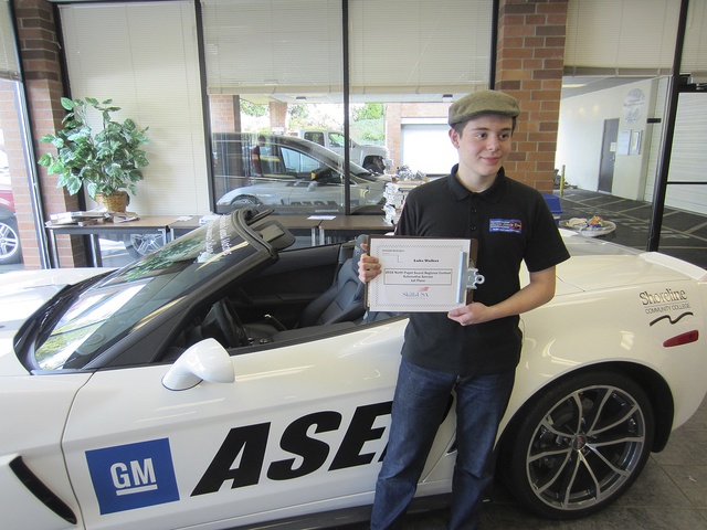 One of the students from the Bellevue School District stands with his award after the Automotive Skills USA regional contest.