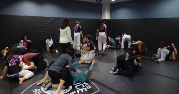 Instructors walk around to support and assist women. (Cameron Sires/ Sound Publishing)