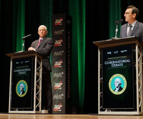 Former Congressman Dave Reichert, a Republican, left, and Washington state Attorney General Bob Ferguson, a Democrat, right, are seen on stage during the second debate of the 2024 Washington state governor’s race, Sept. 18, 2024, in Spokane, Wash. (Bill Lucia/Washington State Standard)