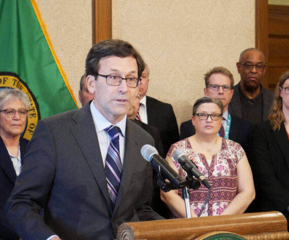 Gov. Bob Ferguson speaks to reporters at the state Capitol on Feb. 27 in Olympia about his plans to cut state spending by about $4 billion over four years. (Photo by Bill Lucia/Washington State Standard)